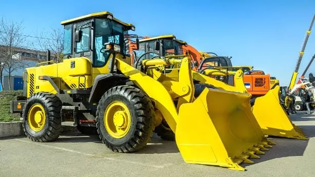 Many Construction Machines In Parking spots