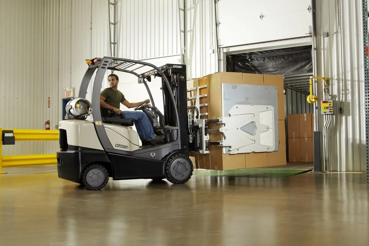 man is carrying forklift