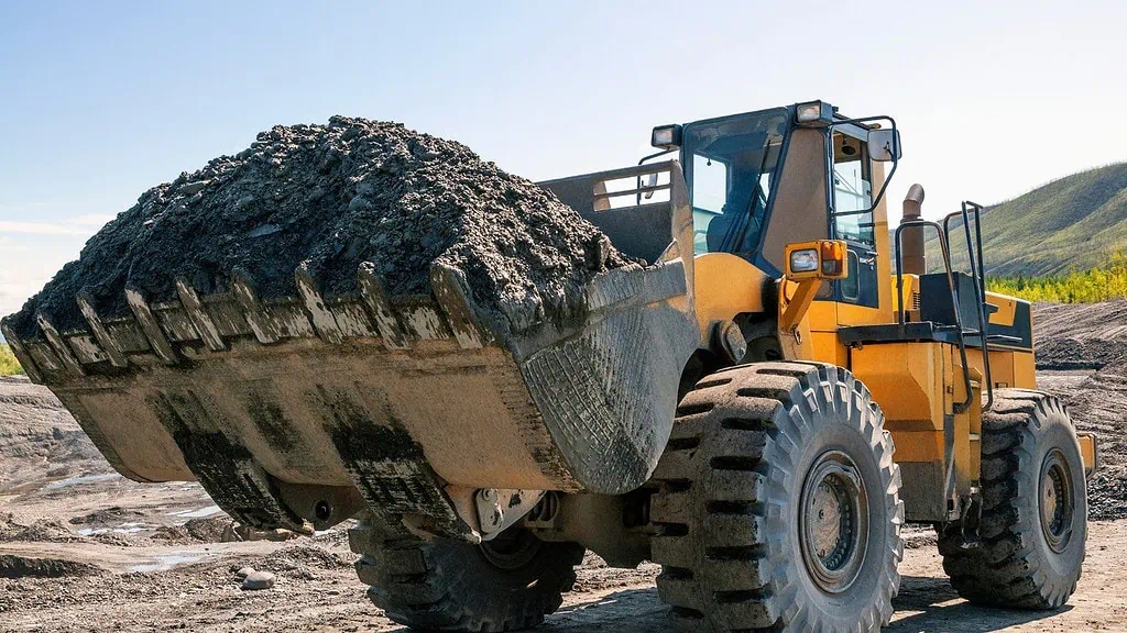 loader carrying dirt and debris